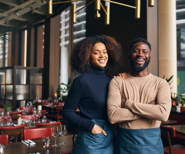 Couple in restaurant smiling 