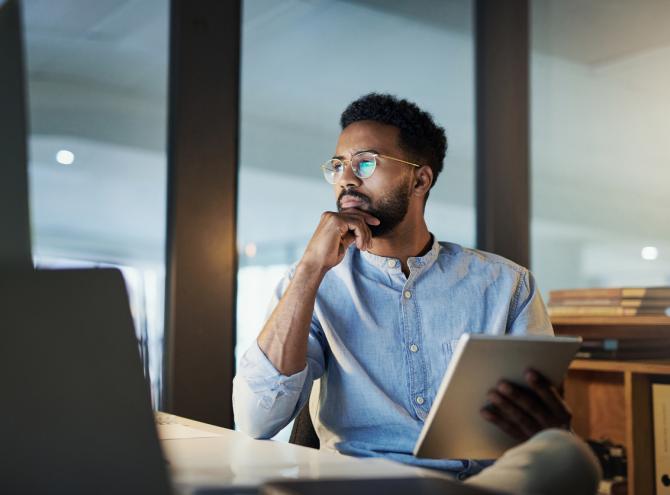 Businessman sitting and looking at computer screen 