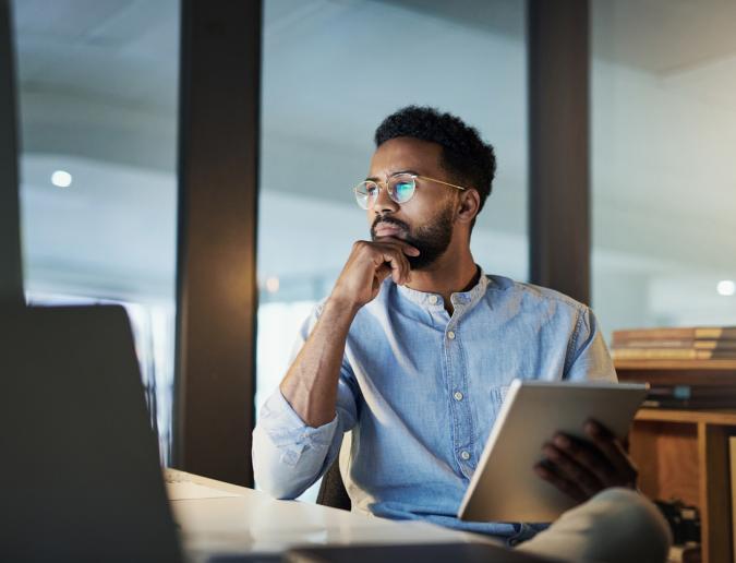 Businessman sitting and looking at computer screen 