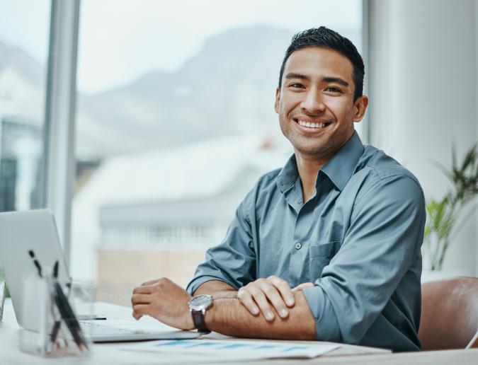 Businessman sitting at desk with laptop